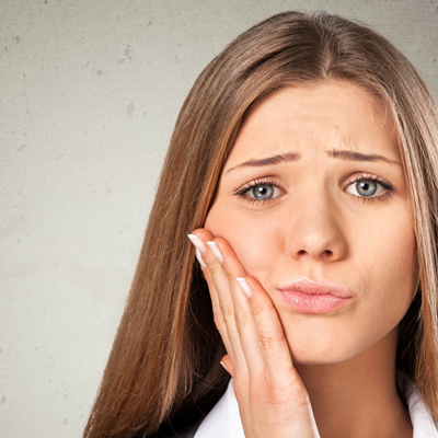 A woman with a aching tooth