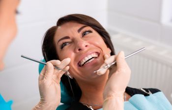 A happy woman with a perfect smile after dental checkup during preventive care dental appointment